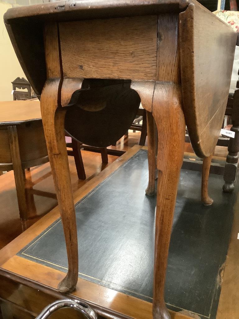 An early 18th century oak oval topped gateleg dining table